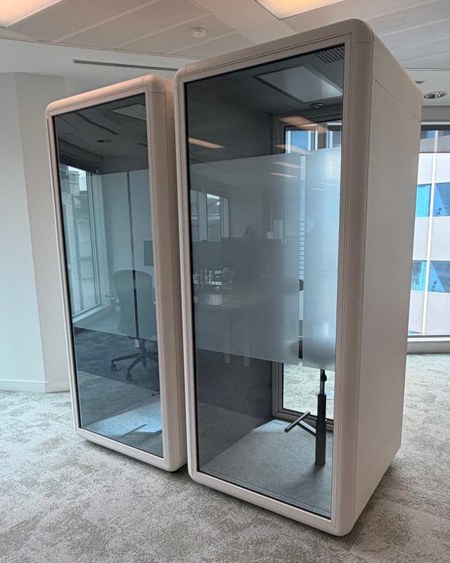 Single-person phone booths, white, in a row